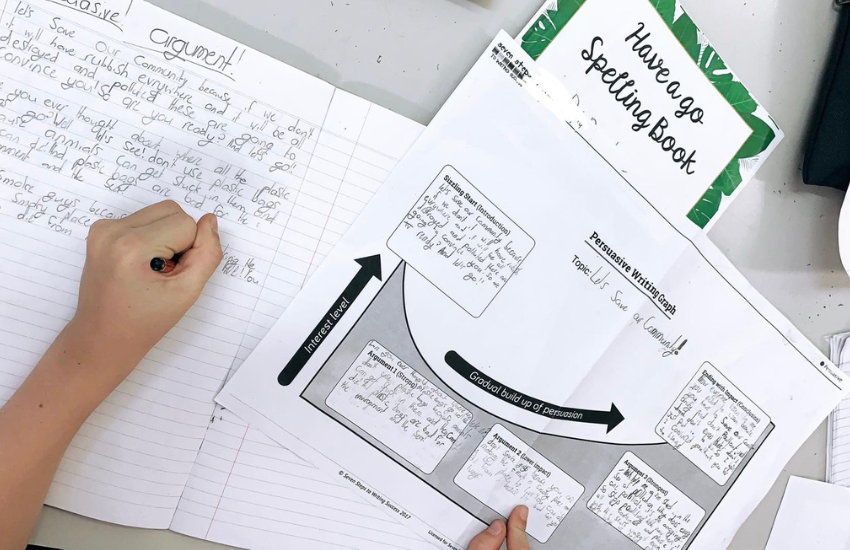 student writing on Seven Steps planning graph demonstrating pebble, rock, boulder.