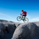 prompt 4: A mountain biker jumping a small gap