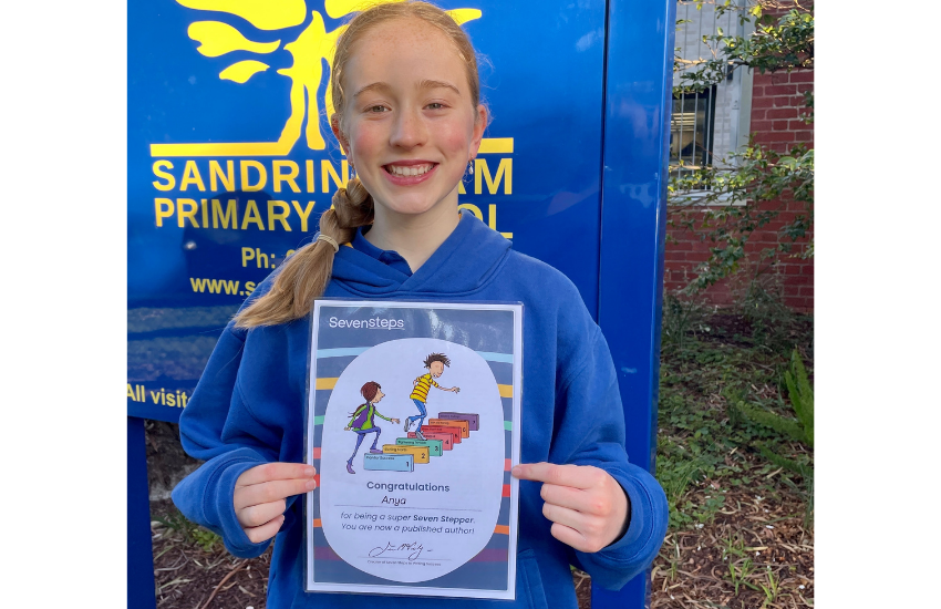 Year 3 student holding her writing certificate