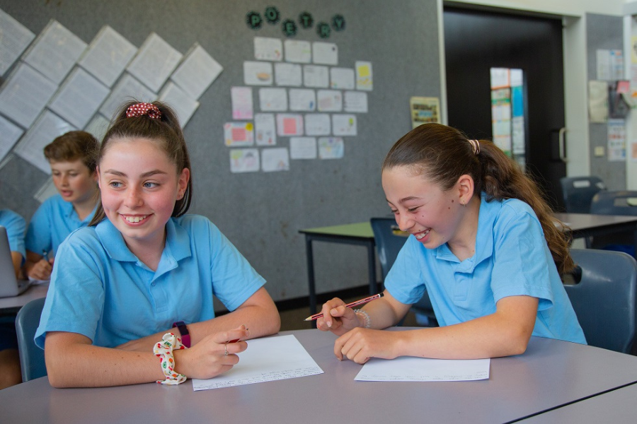 Two students laughing in their narrative writing lesson