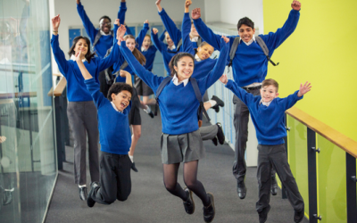 Happy students celebrating writing success.