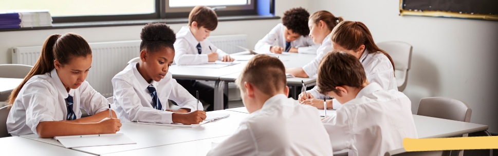 A group of students focused on their writing
